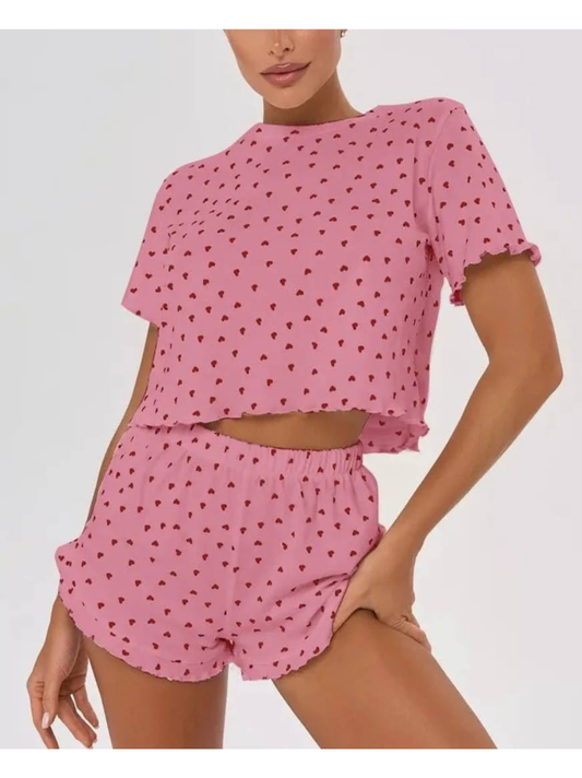 Pink polka dot pajama set on a plain background